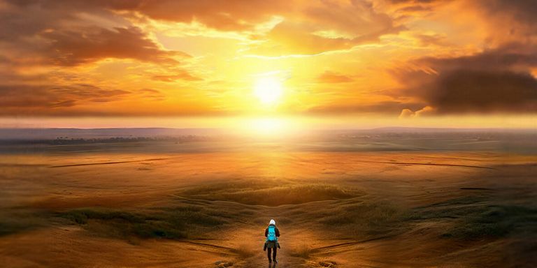guy walking on beach towards sunset